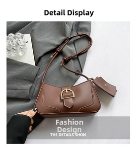 Detailed view of brown faux leather shoulder bag with golden horseshoe buckle and coin purse