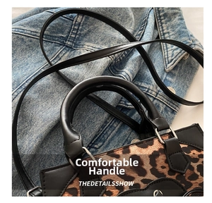Close-up of leopard print patchwork handbag with black leather handle and strap