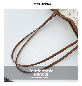 Close-up of deep brown leather shoulder straps with fine stitching on a tote bag