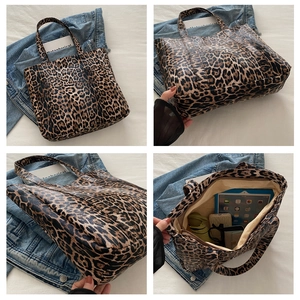 Detail view of leopard print tote bag showing large capacity interior and fabric texture