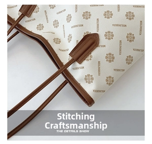 Close-up of pebble grain leather tote bag with vintage monogram and precision stitching
