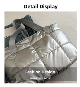 Detail of silver metallic quilted tote bag with square stitching and woven strap