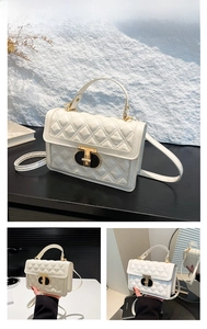 Close-up of white quilted PU leather handbag with golden twist lock and top handle