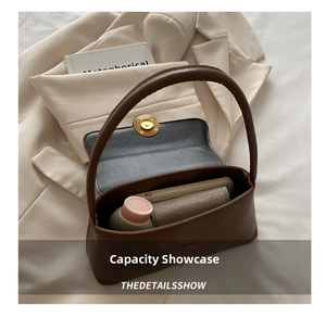 Detail showing internal capacity of the vintage brown leather shoulder bag with items