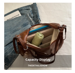 Large capacity brown tote bag interior showing daily items like a laptop and umbrella