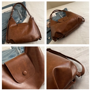 Detail view of a vintage brown leather tote bag showing high-quality texture and stitching