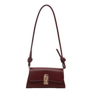 Deep red vintage minimalist baguette bag with gold buckle and knotted strap detail
