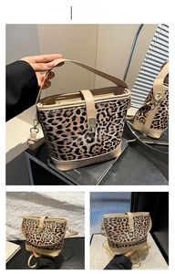 Detail of leopard print bucket bag with khaki leather handles and secure metal clasp
