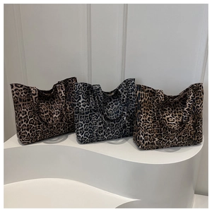 Detailed trio of leopard print tote bags in brown and grey canvas with wide handles