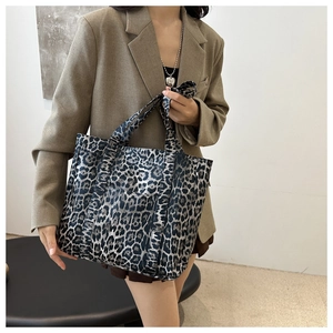 Detail view of large canvas leopard print tote bag with black and grey leopard pattern