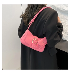 Pink crescent underarm bag with knot detail, gold buckle, and matching mini pouch