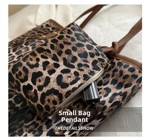 Close-up of leopard print mini bag charm with functional zipper and lipstick storage