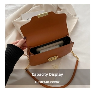 Detail view of brown crocodile texture bag with gold clasp and spacious interior