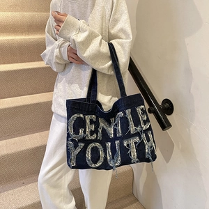 Retro denim tote bag with Gentle Youth lettering and fringe details for daily commute