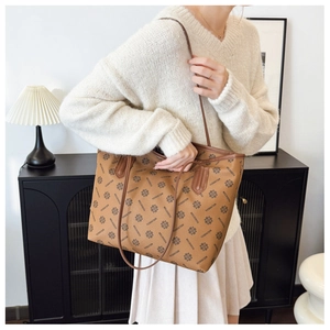 Detail of a large vintage print tote bag shown in a warm, minimalist lifestyle setting