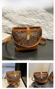 Detail view of brown leopard print bucket bag featuring gold buckle and leather trim