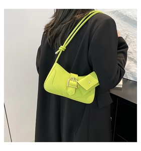 Detail of neon green crescent bag with silver buckle and detachable mini pouch