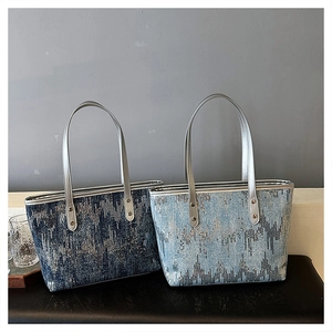 Close-up of sparkling sequins on denim texture tote bag with silver rivets and straps
