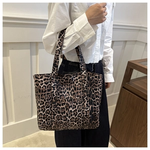Detail of large leopard print tote bag in durable canvas with sturdy top handles