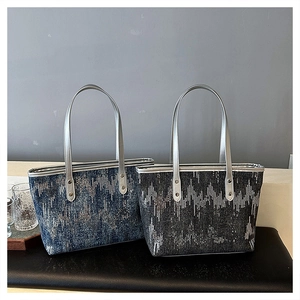 Detail of glitter canvas tote bag showing shimmering sequins and sturdy silver handles