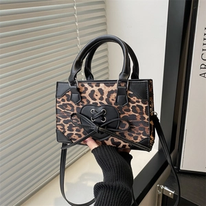 Mini leopard print crossbody bag with heart detail and adjustable black shoulder strap