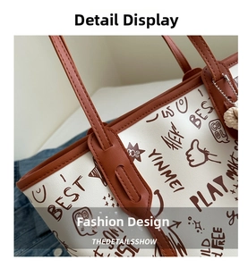 Detail of street graffiti tote bag with creamy white leather and brown shoulder straps
