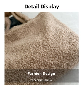 Close-up of beige faux shearling tote bag showing soft fuzzy texture and teddy fabric detail