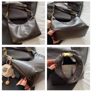 Detail view of brown vintage hobo bag with oil wax texture and cute sheep charm