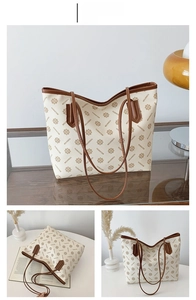 Detail view of large cream tote bag with brown contrast trim and vintage geometric print