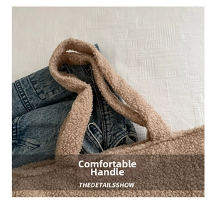 Detail of soft beige plush tote bag handle paired with casual blue denim jeans