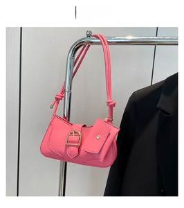 Pink crescent underarm bag with gold metal buckle and matching small pendant detail