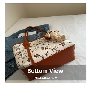 Detail of cute bear graffiti tote bag showing its wide brown leather reinforced bottom