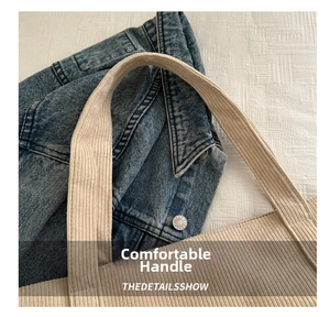 Detail of wide soft corduroy handles on a beige tote bag showing striped fabric texture