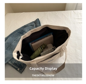 Interior view showing large capacity of the beige corduroy tote bag with daily essentials