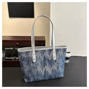 Detail of blue sequin wave texture and silver trim on a large tote commute bag