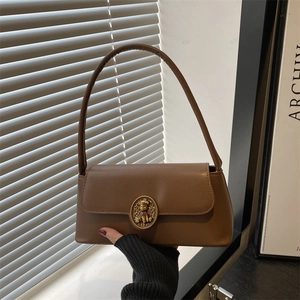 Retro brown leather underarm bag with a golden bear clasp and elegant shoulder strap