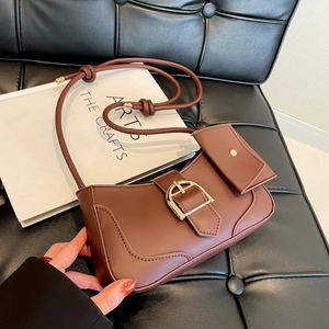 Dark brown crescent underarm bag with gold horseshoe buckle and drawstring strap detail