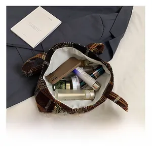 Interior view showing the large storage capacity of the plaid tote bag with magnetic clasp