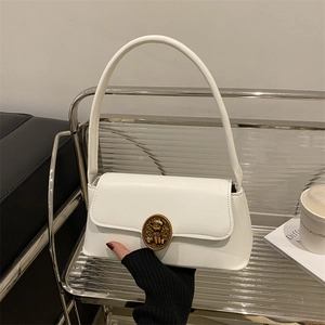 Chic white leather underarm bag with vintage gold buckle on a modern metal stand
