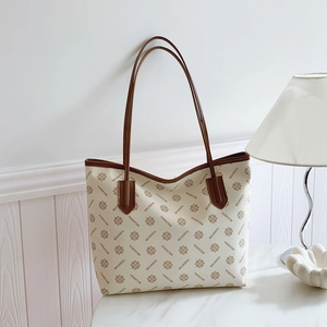 Large vintage monogram tote bag for women in cream and brown PU leather on marble surface
