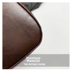 Macro detail of dark brown litchi grain leather texture and high-quality edge stitching