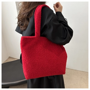Shoulder view of large red plush tote bag in high-quality teddy faux fur material