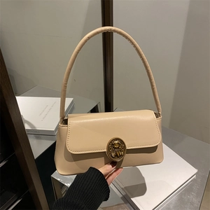 Retro beige leather underarm bag with vintage metal bear buckle on a rectangular flap