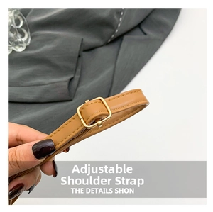 Detail of adjustable brown leather shoulder strap with gold buckle for women square bag