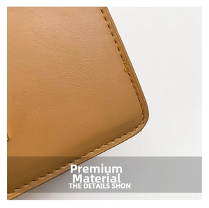 Close-up of brown pebbled leather texture and neat stitching on a chain crossbody bag