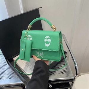 Neon green crossbody bag with skull print and matching mini pouch for women