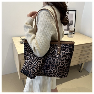 Detail of leopard print tote bag with brown leather handles and matching small coin purse