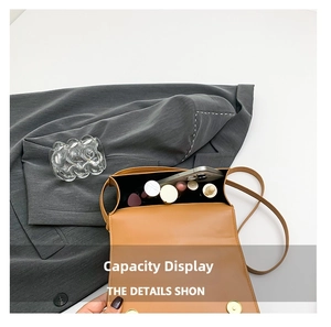 Interior view of brown PU leather crossbody bag showing capacity for phone and lipstick