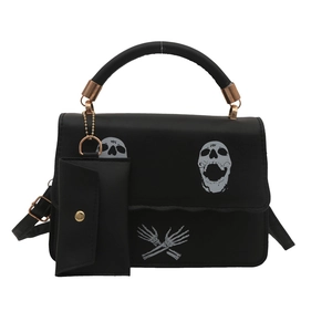 Black punk style crossbody bag featuring white skull prints and a small coin pouch