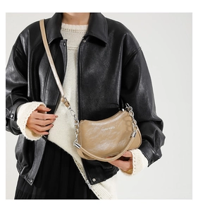 Detail of light brown crescent shoulder bag with chain and Fashion & Bags text